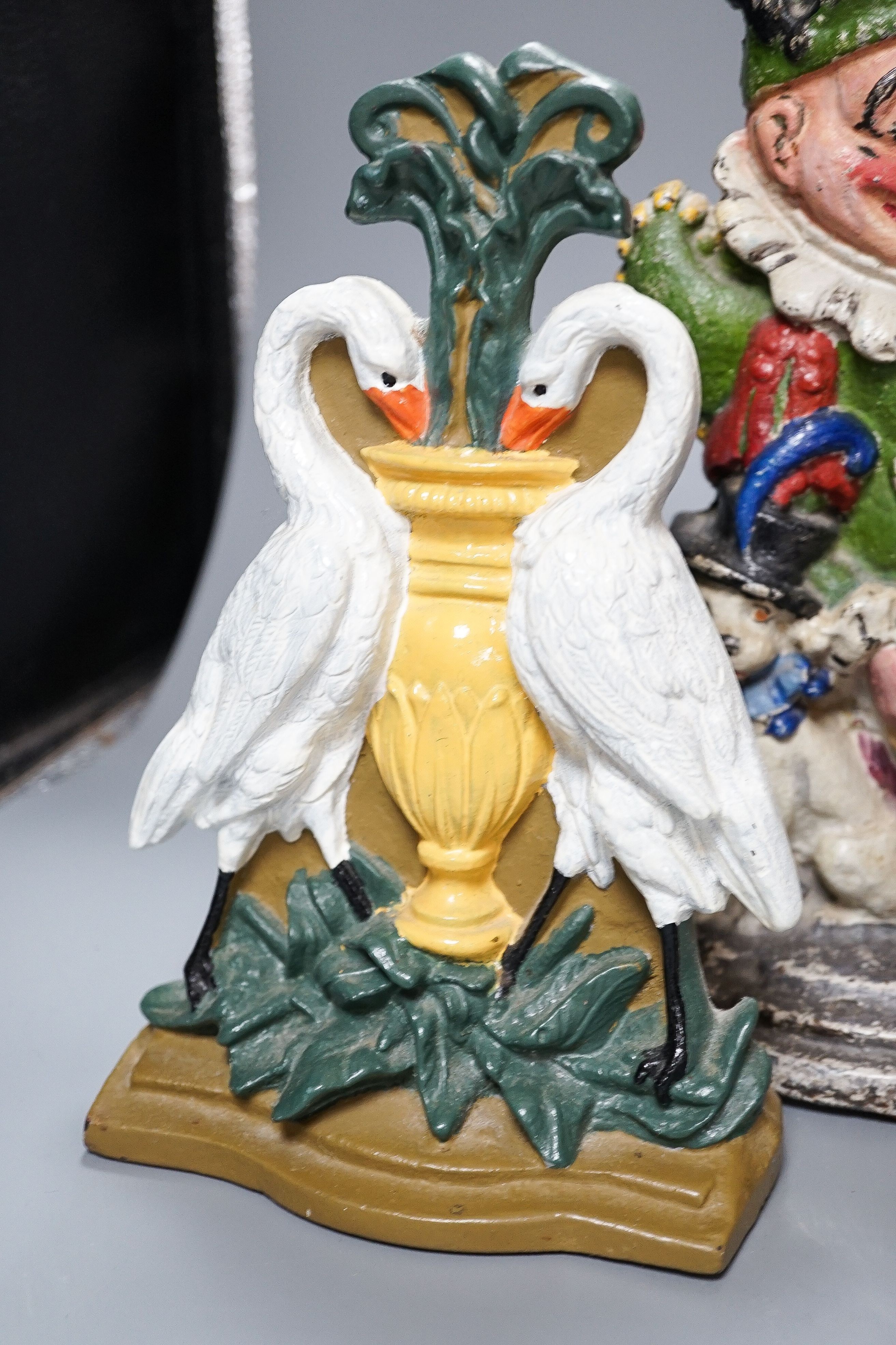 Three Victorian painted cast iron door stops (re-painted) 31cm and a later figure